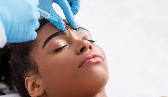 woman taking injection at Gulfcoast Eye Care